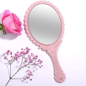 Miroir à main ovale décoratif rose